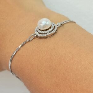 PULSERA DE PLATA RODINADA MODELO CIRCULO CON PERLA Y PIEDRAS